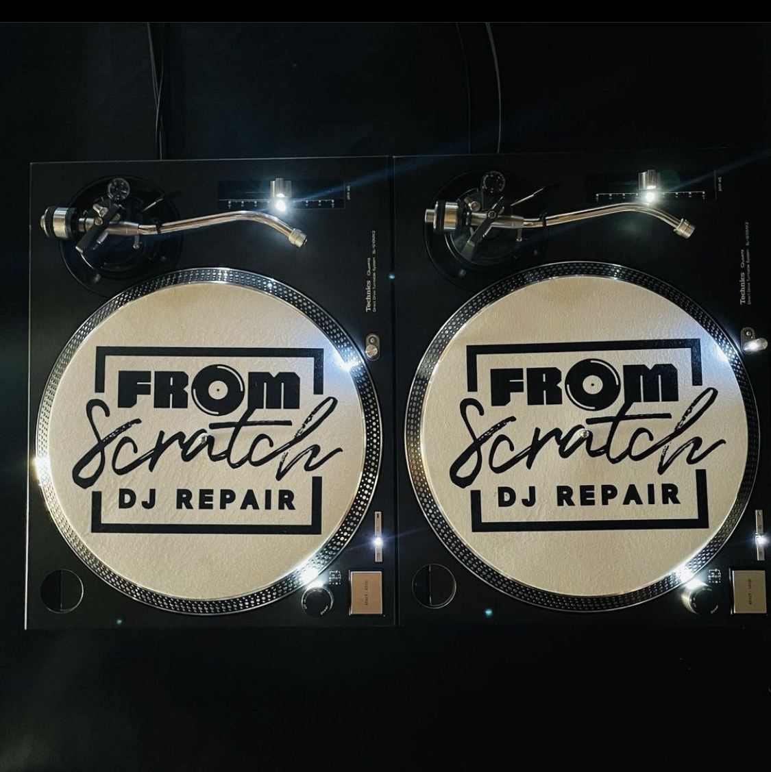 From Scratch DJ Repair branded slipmats on a pair of Technics turntables